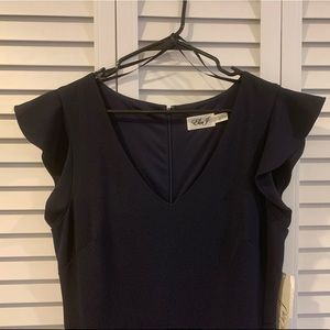 Navy blue ruffle sleeve pants romper with pockets.